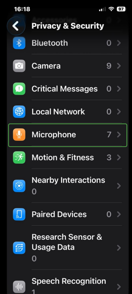 iPhone Privacy & Security settings with Microphone highlighted.