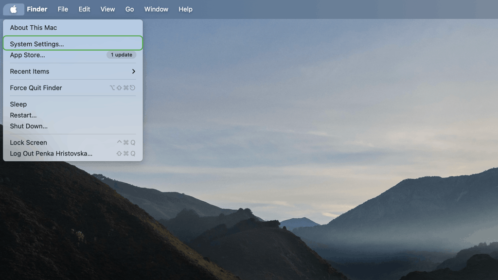 Mac desktop with Apple menu open, highlighting “System Settings.